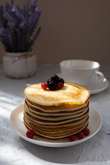 Pancakes with summer berries on a plate for breakfast