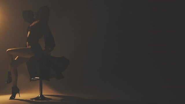 Woman sitting on a bar stool in the smoke