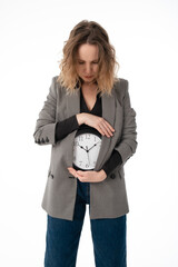 A woman holds a watch on her stomach. Pregnancy, menstruation, biological clock concept. Isolated...