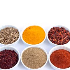 Different organic spices in bowl isolated on white