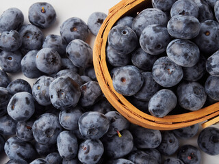 Blueberry fruit top view isolated on a white background, flat lay overhead layout with mint leaf, healthy design concept.