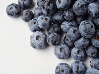 Water drops on ripe sweet blueberry. Fresh blueberries background with copy space for your text. Vegan and vegetarian concept. Macro texture of blueberry berries.Texture blueberry berries close up