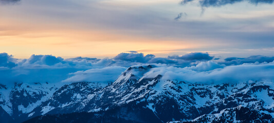 Aerial Panoramic View from Airplane of Canadian Mountain Landscape in Spring time. Colorful Sunset Sky. North of Vancouver, British Columbia, Canada. Nature Background Panorama, Authentic Image