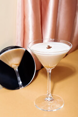 Glass of espresso martini reflected in mirror
