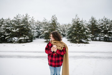 Happy Girl In Red Jachet The Snow Forest. Cold Winter. Cup of tea.