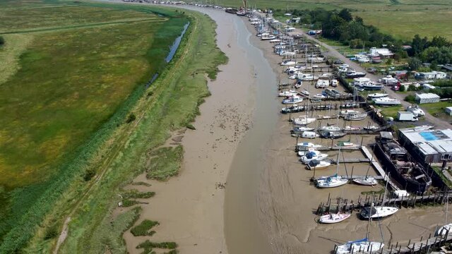 4K video of a drone slowly decending over a creek at low tide