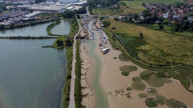 4K drone footage flying towards leisure boats in dry docks.