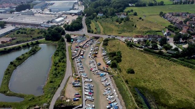4K drone footage flying over leisure boats in dry docks