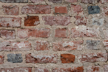 Old brick wall. Grunge background with red bricks and cement layers.