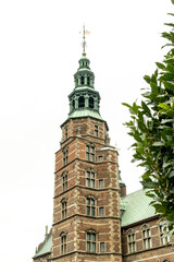 Fototapeta na wymiar Rosenborg Castle tower and cloudy sky. Copenhague, Denmark. 