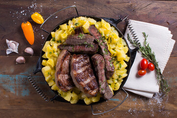 meat with vegetables on wooden table top view
