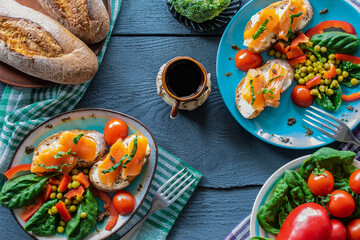 Photocomposition: Breakfast, sandwich with salmon, herbs and vegetables, on a wooden background, top view
