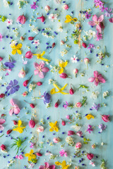 Wooden background with small flowers, good morning, top view
