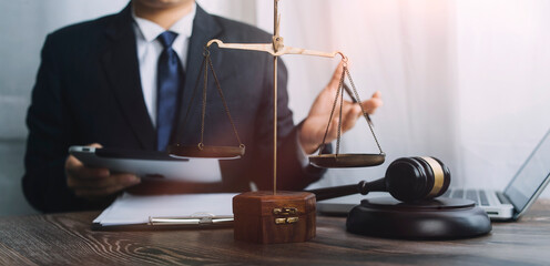 justice and law concept.Male judge in a courtroom on wooden table and Counselor or Male lawyer...