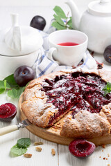 Summer open pie or galette with red plums.