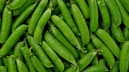Raw green pea pod close up, top view