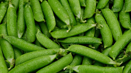 Raw green pea pod close up, top view