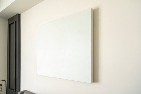 Empty canvas, poster, blank frame canvas, mock up, on a white wall, living room, home decoration template, angle view