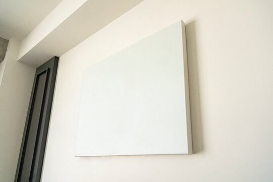 Empty canvas, poster, blank frame canvas, mock up, on a white wall, living room, home decoration template, low angle view