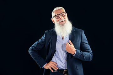 Happy senior businessman with white beard smiling and looking at camera.