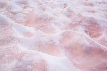 White and pink melted snow interspersed with red lies bumps