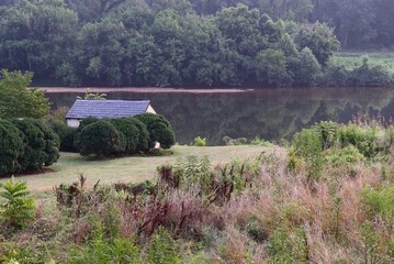 Scenic Riverbank, Trees, Outbuilding, Reflection in Water