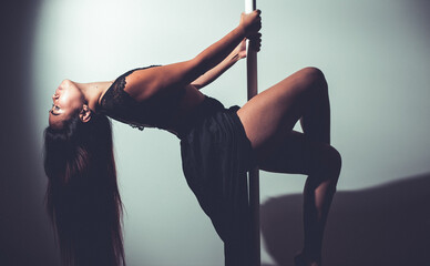 young asian woman doing pole dance at home