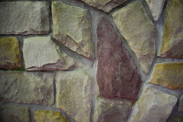 Texture lined with stone on the wall, of different shapes and shades for the whole frame