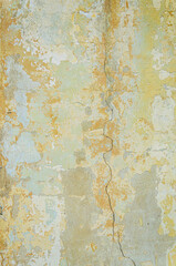 Old wall for background, rough aged surface, remnants of peeling plaster, multi-colored grunge-style multi-layer crustr, strong uneven texture, crack in the wall, above close-up wallpaper
