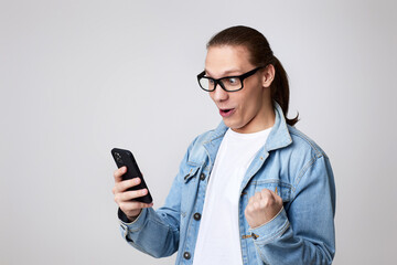 young man in glasses using smart phone