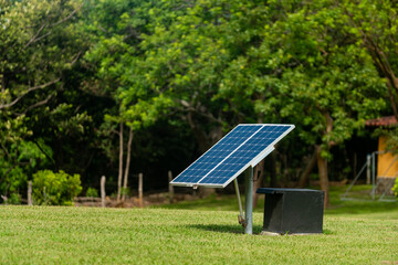 Panel solar en un area verde, captando luz solar para convertirla en electricidad