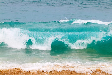 Powerful ocean blue waves with white foam. Marine background.