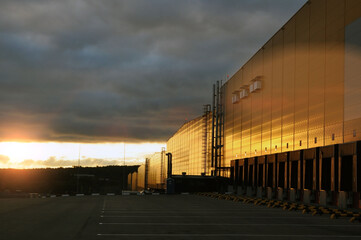 Warehouse logistics complex in the rays of the rising sun.