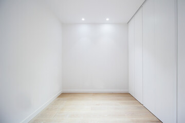 empty room with door closets and white walls