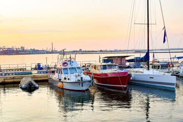 Private sailing yachts are moored in the sea at the pier.