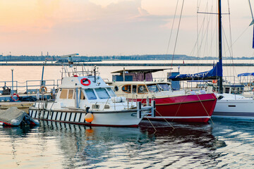 Anchorage with sailing yachts on the sea in the yacht club against the backdrop of the evening sky...