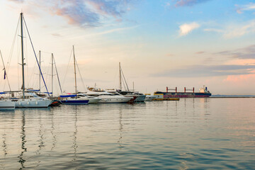 Anchorage with sailing yachts on the sea in the yacht club against the backdrop of the evening sky...
