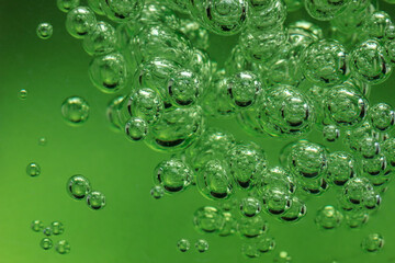 Lots of air bubbles in the green liquid. Macro image.