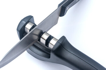 Knife - fillet knife and reversible manual knife sharpener. Items on a white background.