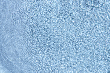 Blue water background, drops and waves on the water with glitter