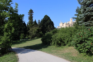 A path leading through the castle garden with a view of Lednice castle. Czech history. Lednice-Valtice area in the Czech Republic.