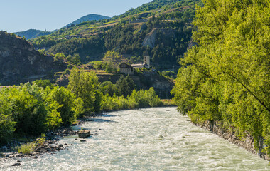 Fototapeta na wymiar Beautiful late afternoon sight of the Dora Baltea river near Aosta. Aosta Valley, northern Italy.