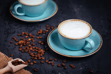 Cups of coffee on a rustic wooden background