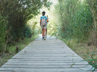 Caucasian girl feet on forest excursion with backpack