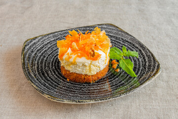 wonderful individual carrot cake with two layers, one ice cream and one sponge cake and the top of carrot and caramel chips