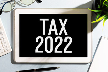 TAX 2022. Tablet, calculator. Accounting concept. Flat lay.