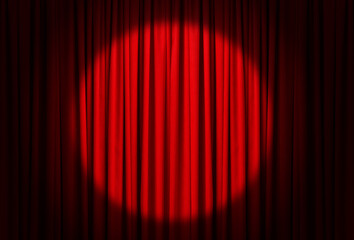 Spotlight illuminating closed red stage curtains. Start of performance