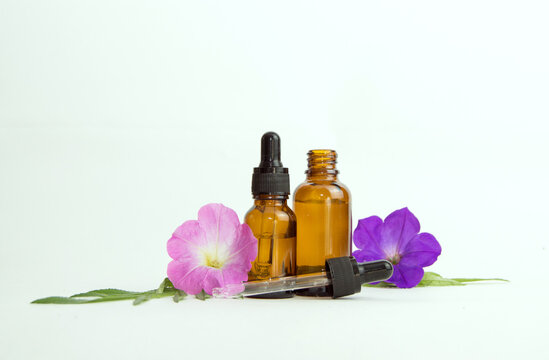 aromatherapy, essential oils with delicate flowers on a light background. place for text, spa brochure