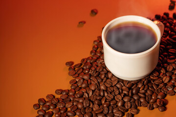 Warm cup of coffee and coffee beans on brown background. Coffee cup and coffee beans on the table