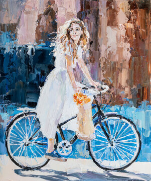 A girl in a white dress rides a bicycle.